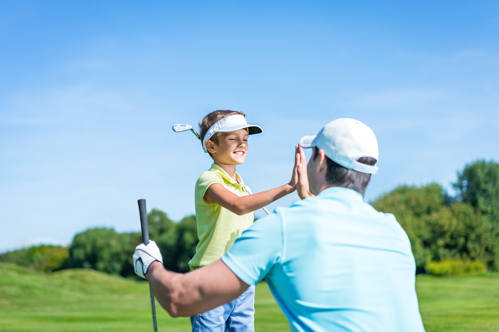 Dad and son playing golf